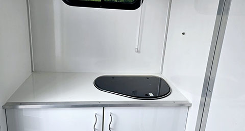 the stove and wash area inside of HCS Horse Transport's horse box